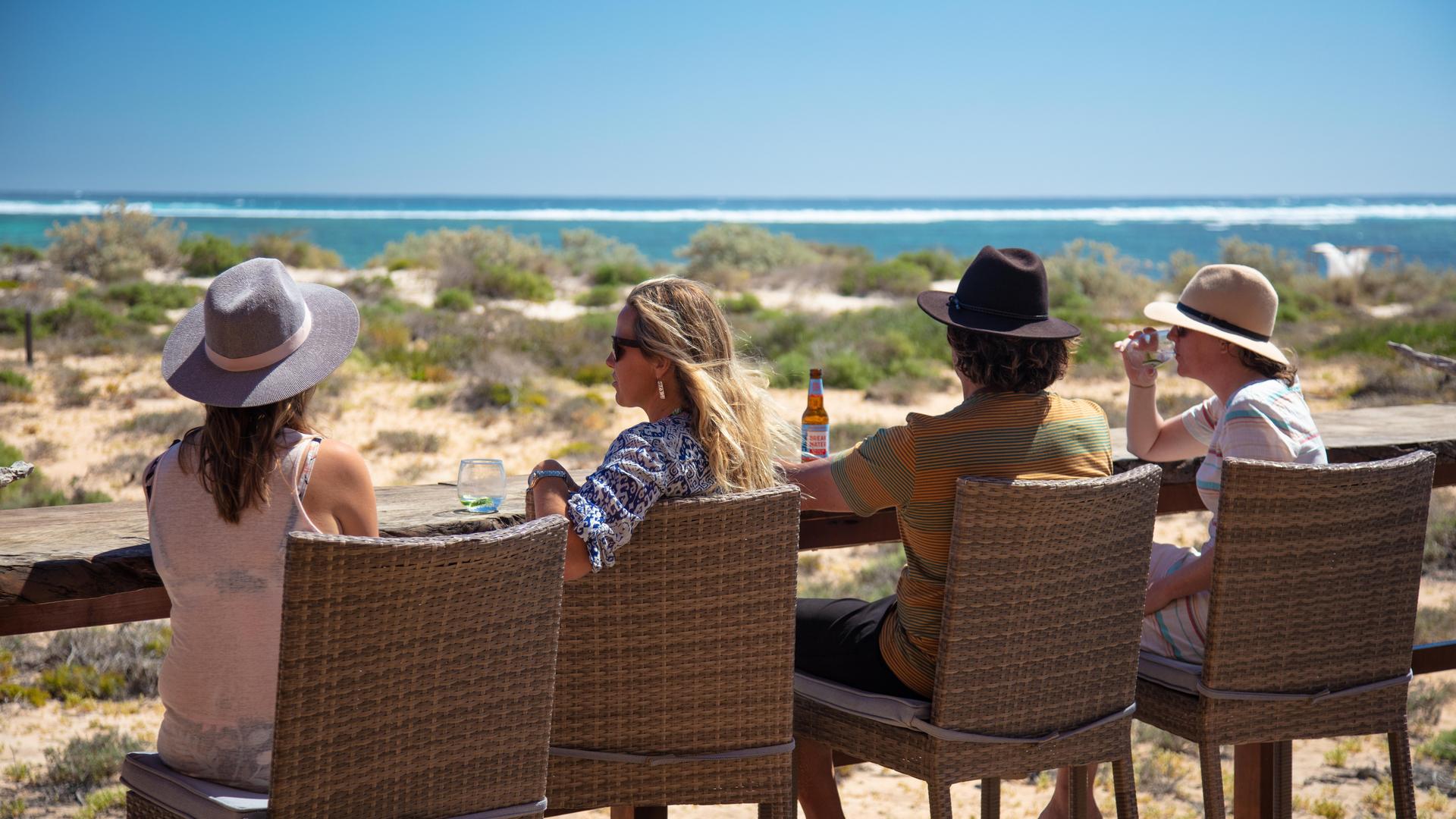 women enjoying a drink looking out over ningaloo reef