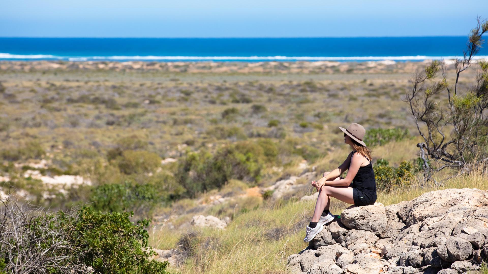 woman sitting on rock at national park